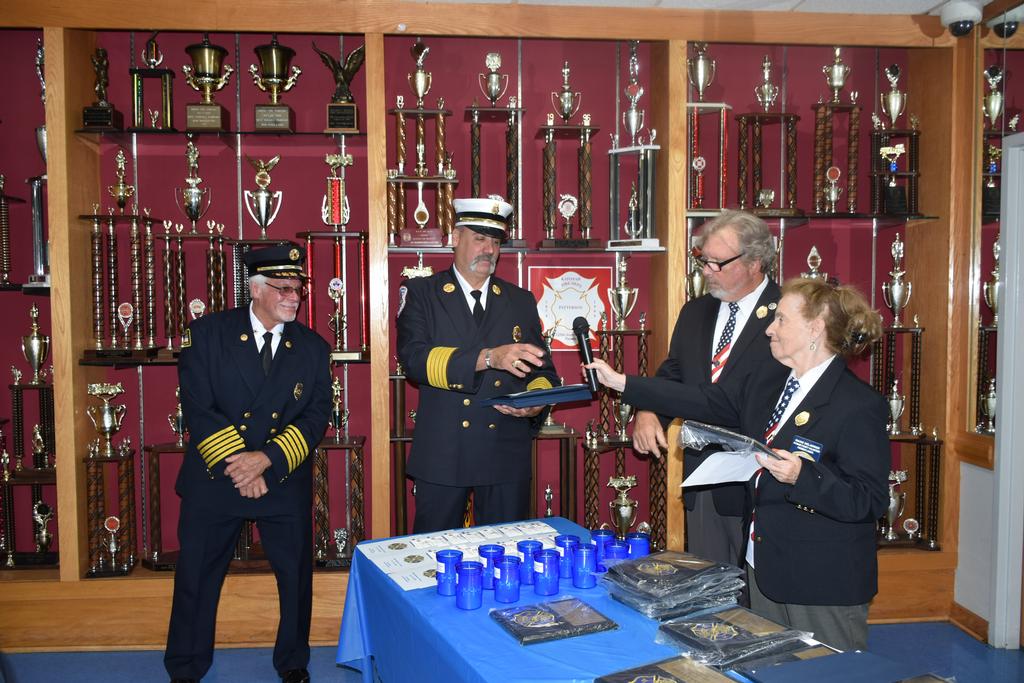 (L-R) 50-yr member Chief Ed Butler, Cmsr. Ken Clair, Chairpersons Mike Doherty, Marie Delawder