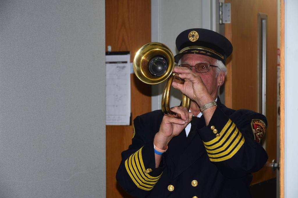 Chief Butler plays TAPS to end the convention meeting and finalize the Memorial Service